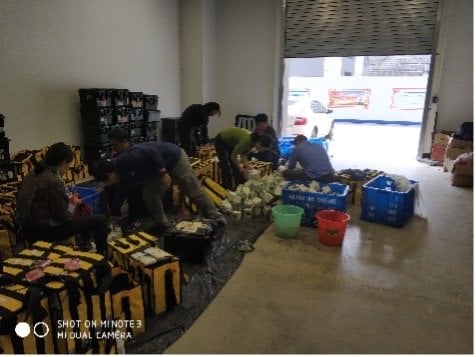 Workers in a warehouse prepare SmartSolo nodes and seismometers for geophysical exploration and seismic survey.