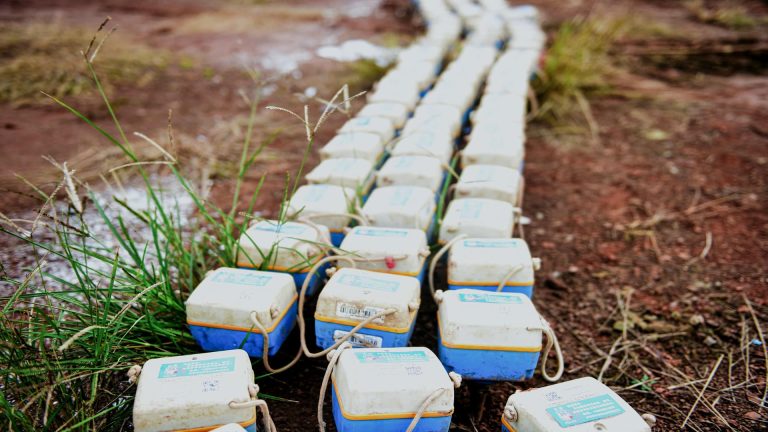 Rows of SmartSolo nodes, seismometers used for seismic survey and geophysical exploration, laid out on the ground.