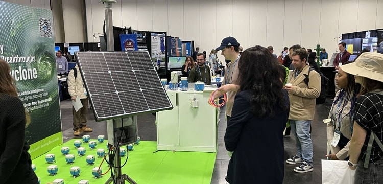 A solar panel powers SmartSolo nodes for seismic surveys and geophysical exploration at a trade show booth.