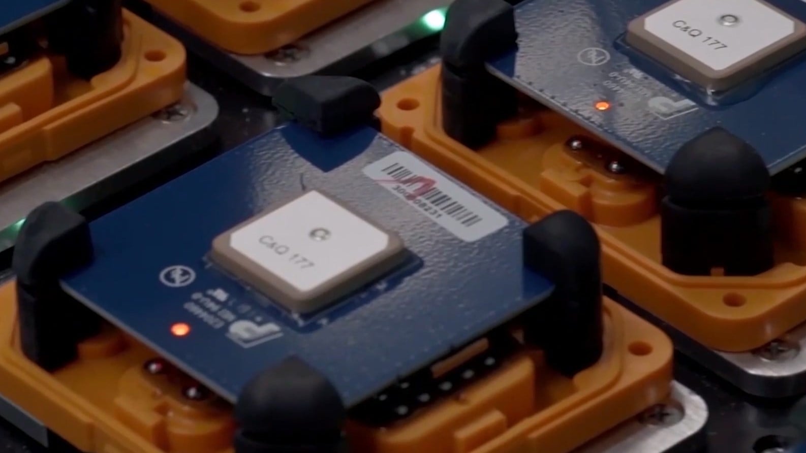 Detailed view of a SmartSolo node's circuit board with chips and illuminated indicator lights, essential for seismic survey.