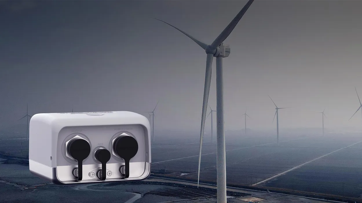 Seismic monitoring equipment with ports labeled "SENSOR," "GPS," and "POWER/DATA," set against a backdrop of wind turbines, illustrating applications in renewable energy site assessment.